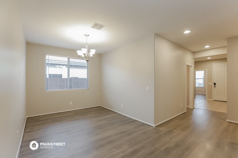 the living room and dining room of an empty house