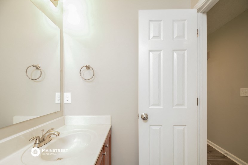 a bathroom with a sink and a white door