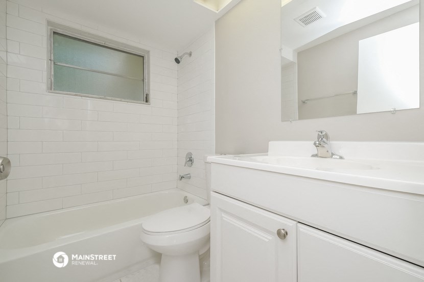 a white bathroom with a sink and a toilet