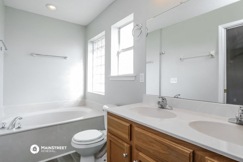 a bathroom with a sink and a toilet and a bath tub