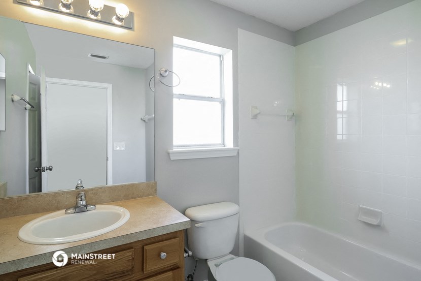 a bathroom with a sink and a toilet and a bath tub