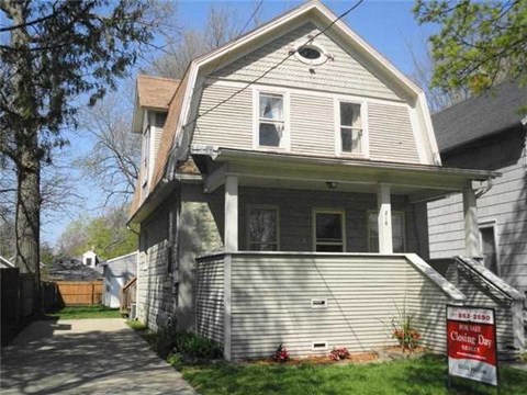 a house with a foreclosure sign in front of it