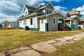 a white house with a sidewalk in front of it