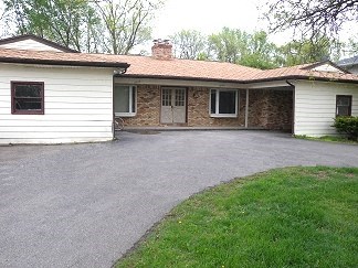 a white house with a driveway in front of it