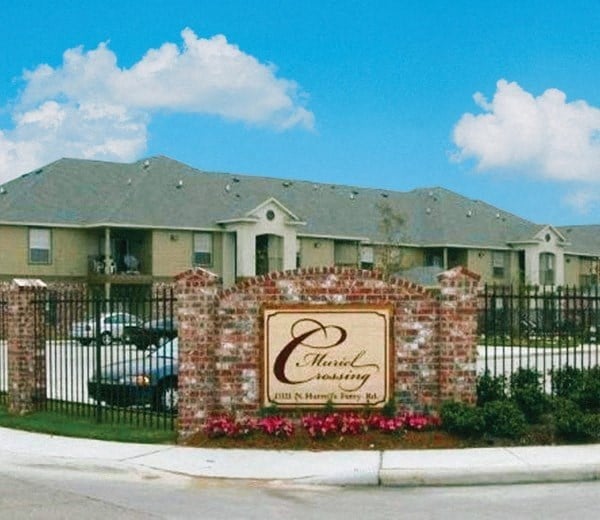 a house with a sign in front of a fence