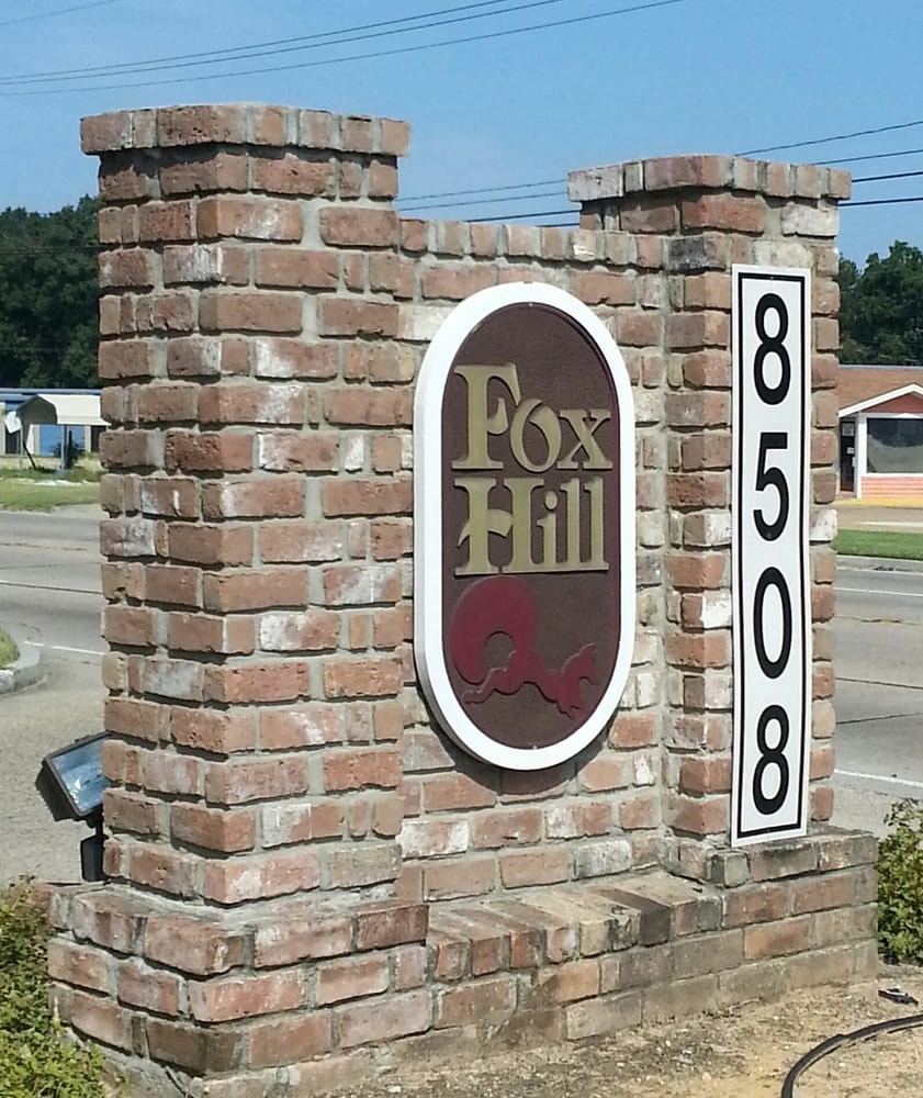 a brick pillar with a sign