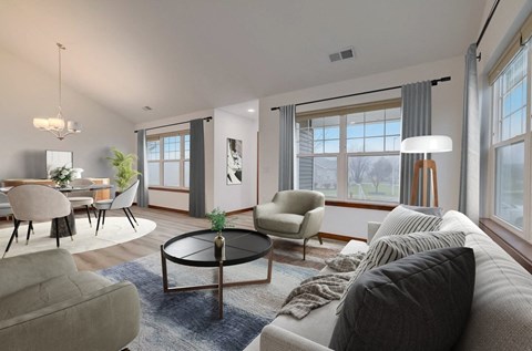 the living room of an apartment with a couch and chairs