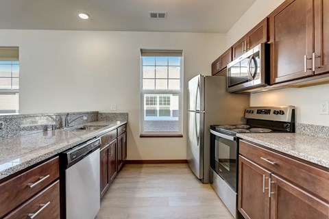 a kitchen with stainless steel appliances and granite counter tops