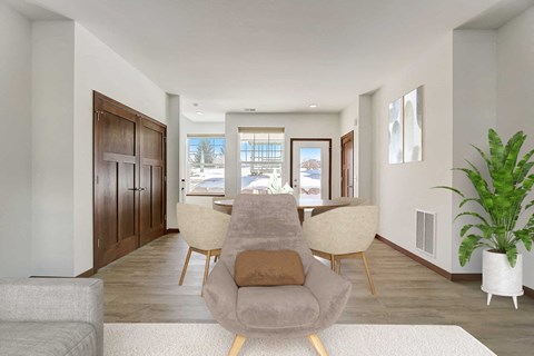 a living room with a couch and a table with chairs