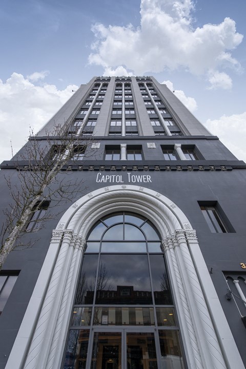 A tall building with a sign that says Capitol Tower.