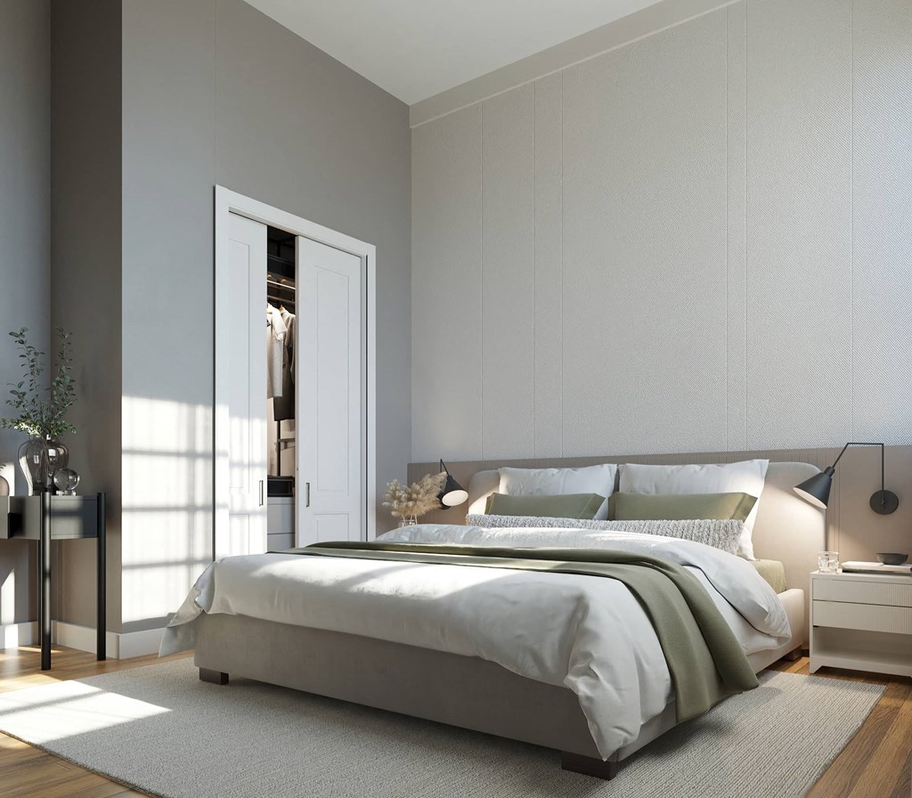 a bedroom with grey walls and a white bed