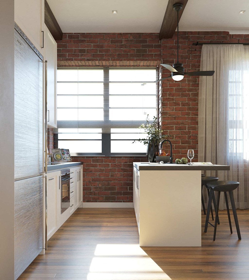 a kitchen with a counter and a brick wall