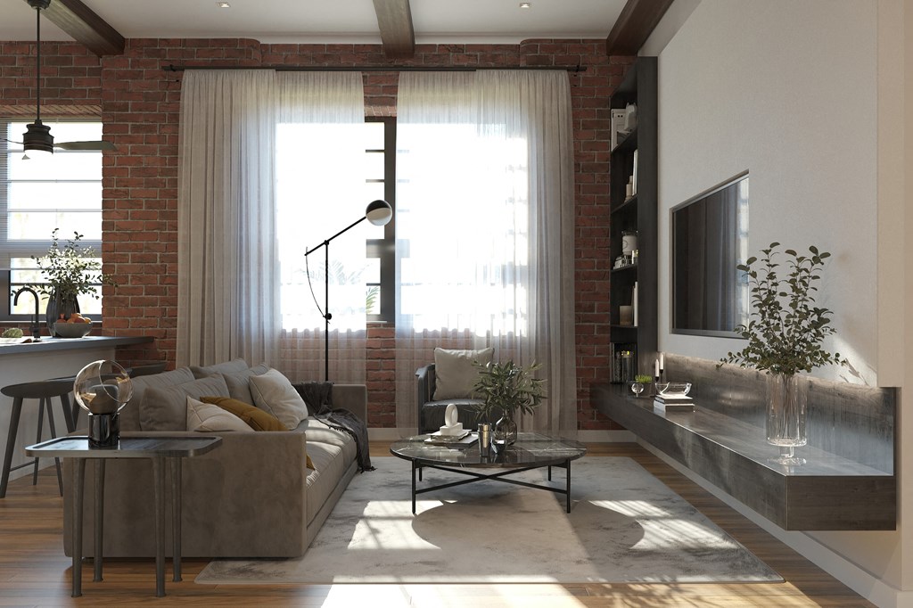 a living room with a couch and a table in front of a window