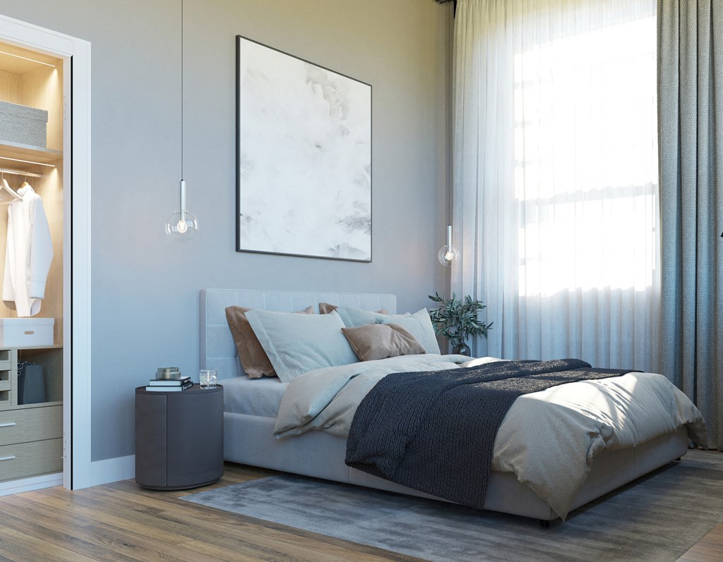 a bedroom with blue walls and a bed with pillows