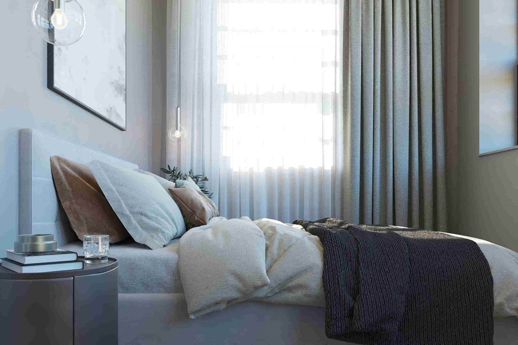 a bedroom with a bed and a window with curtains