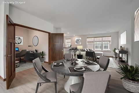 a living room and dining room with a table and chairs