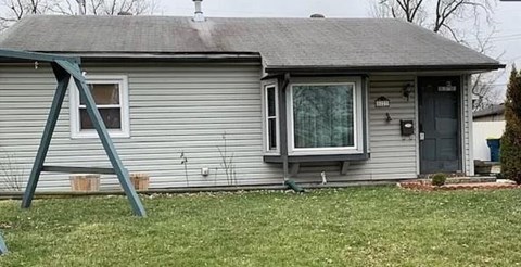 A house with a grey roof and a grey door.