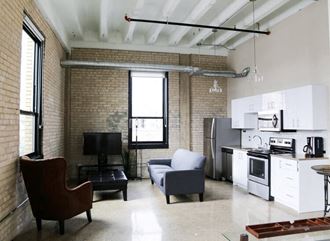 an open kitchen and living room in a loft