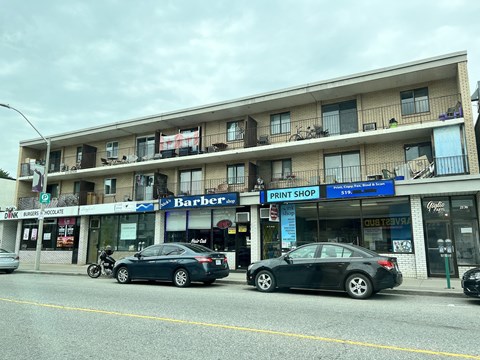 a city street with cars parked in front of a building