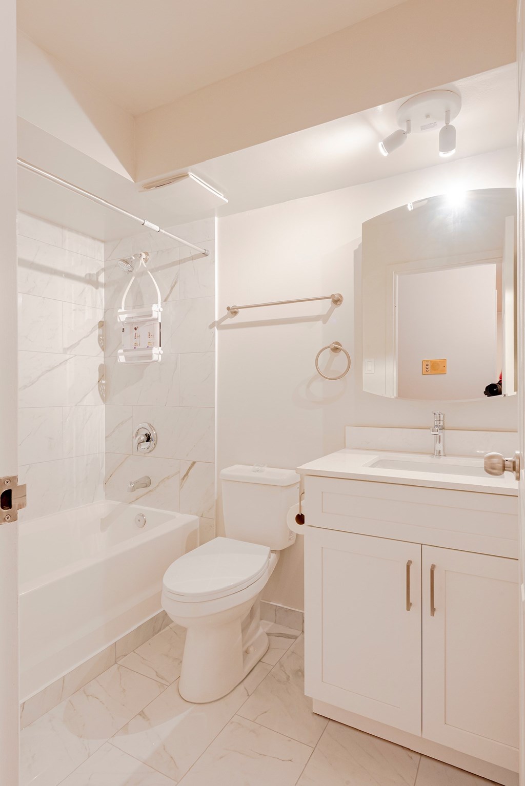 a white bathroom with a toilet sink and shower