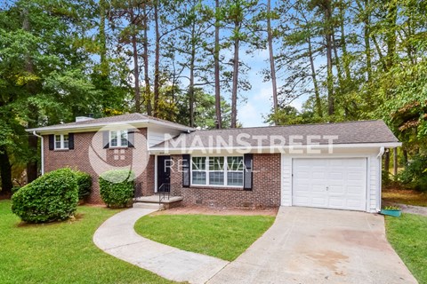 a brick house with a driveway and a white garage door