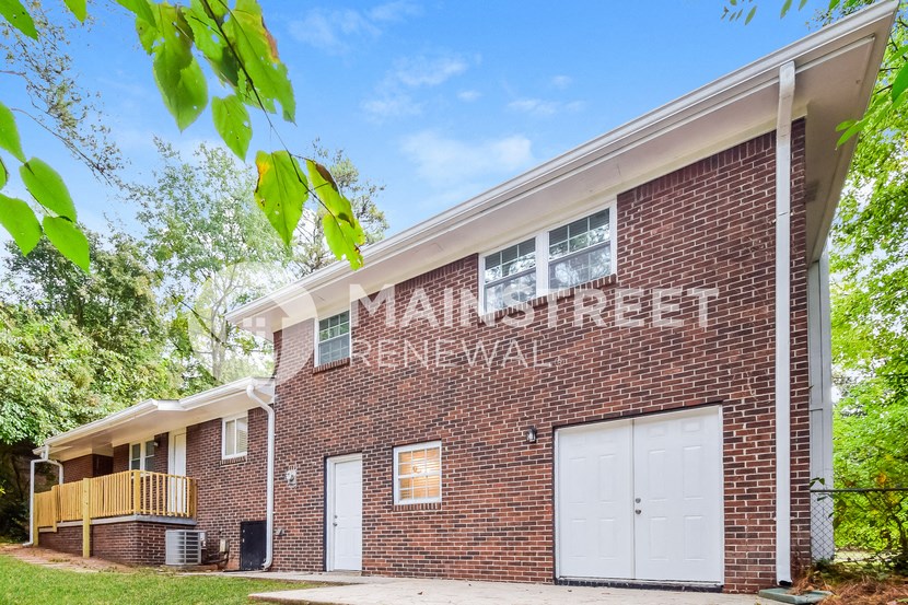 a brick building with two white garage doors
