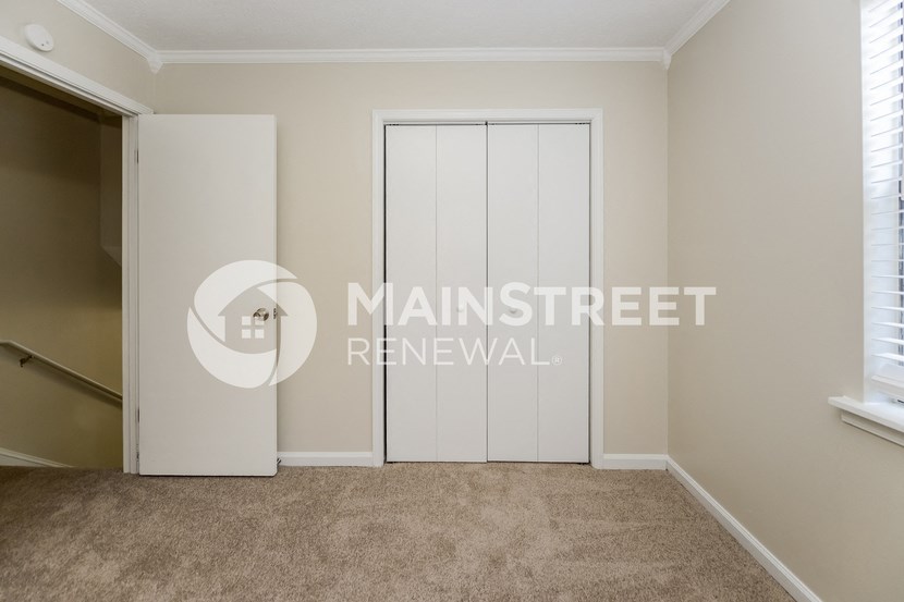 a bedroom with a closet and a closet door