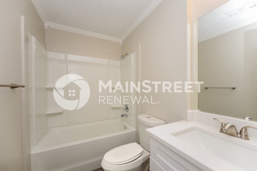 a small bathroom with a toilet and a tub