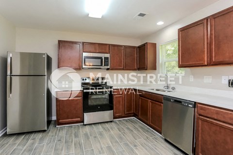 a kitchen with wooden cabinets and stainless steel appliances