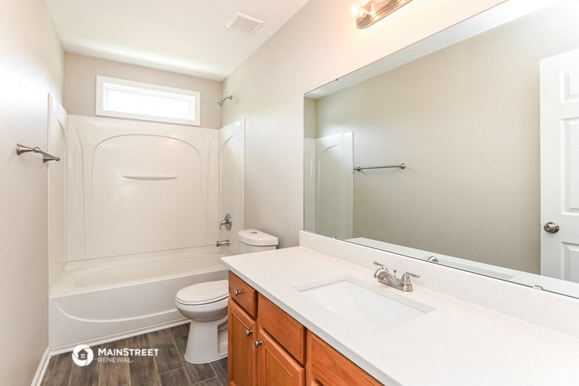 a bathroom with a sink and a toilet and a mirror