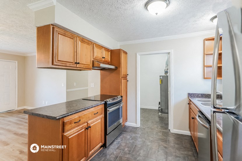 a kitchen with wooden cabinets and stainless steel appliances