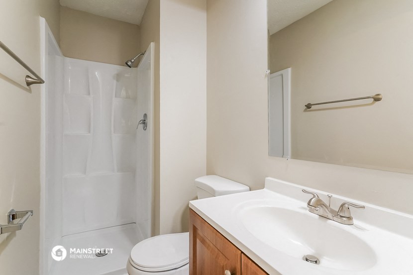 a bathroom with a sink and a shower and a toilet