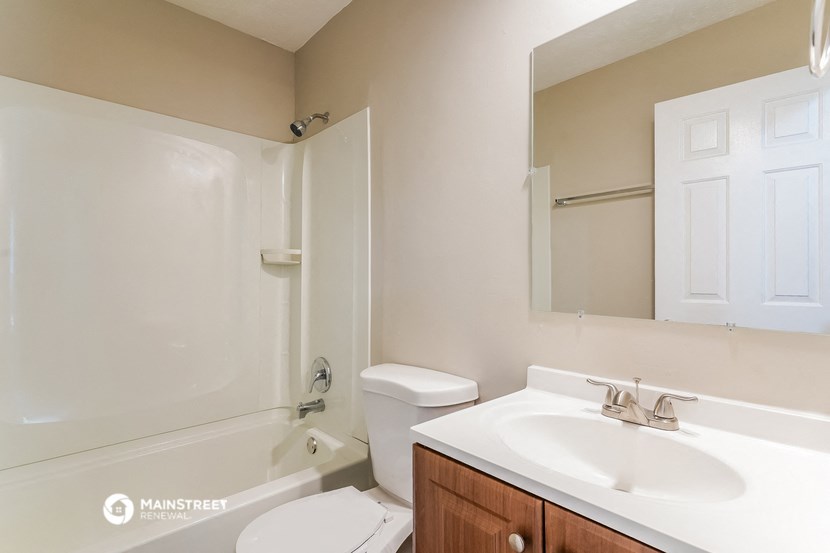 a bathroom with a sink and a toilet and a shower