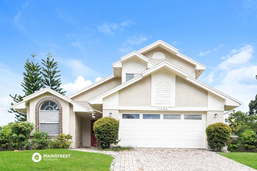 a house with a white garage door and a lawn