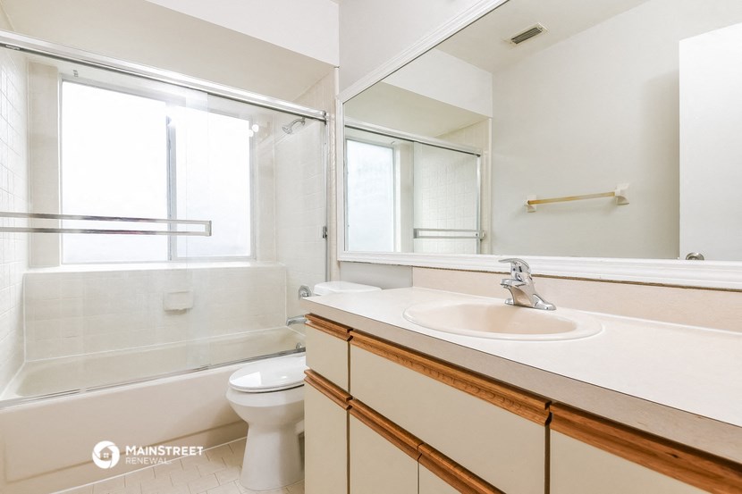 a bathroom with a sink and a toilet and a shower