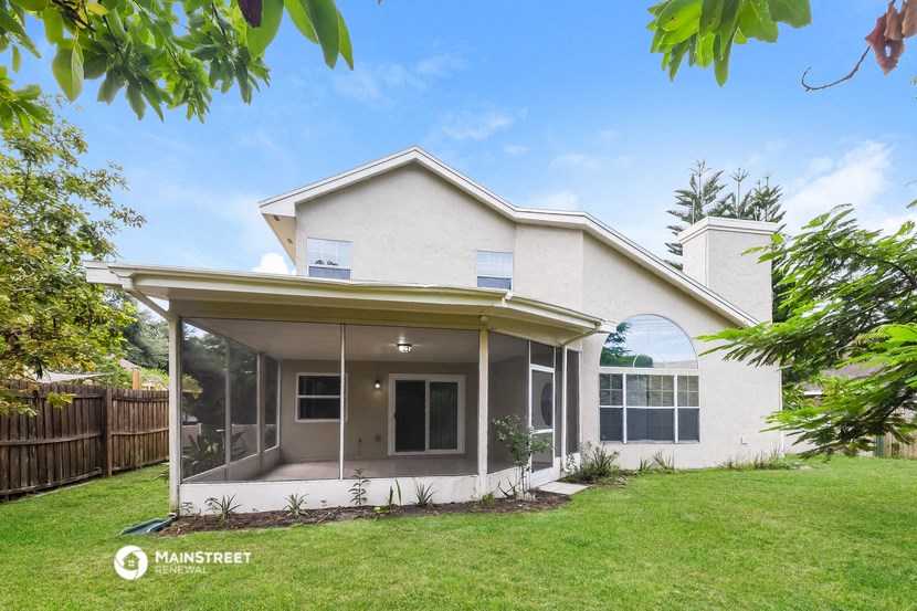a white house with a yard and a patio