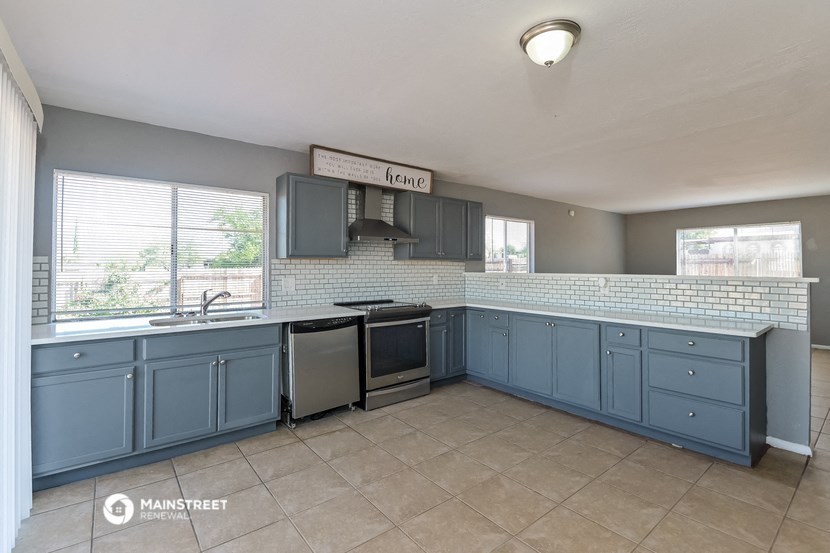 the kitchen has plenty of counter space and stainless steel appliances
