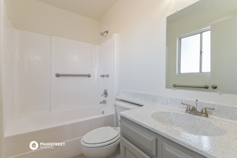 a bathroom with a sink and a toilet and a bath tub