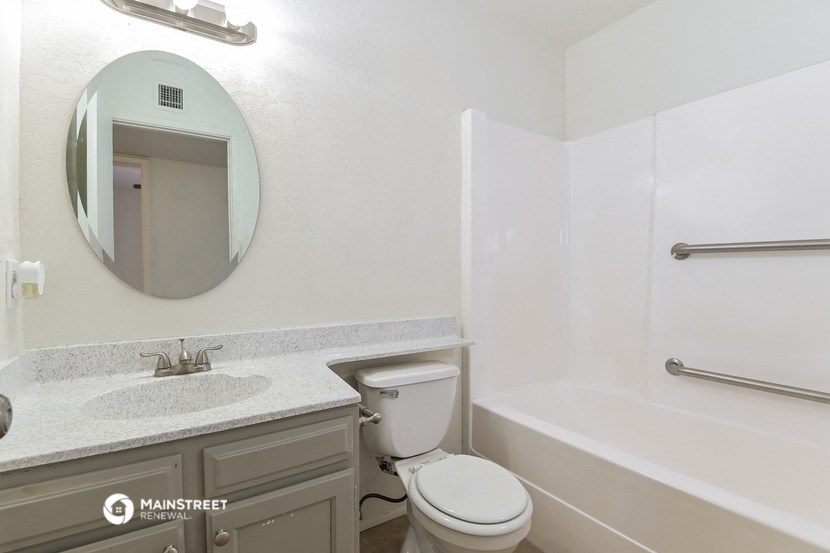 a bathroom with a toilet and a sink and a bath tub