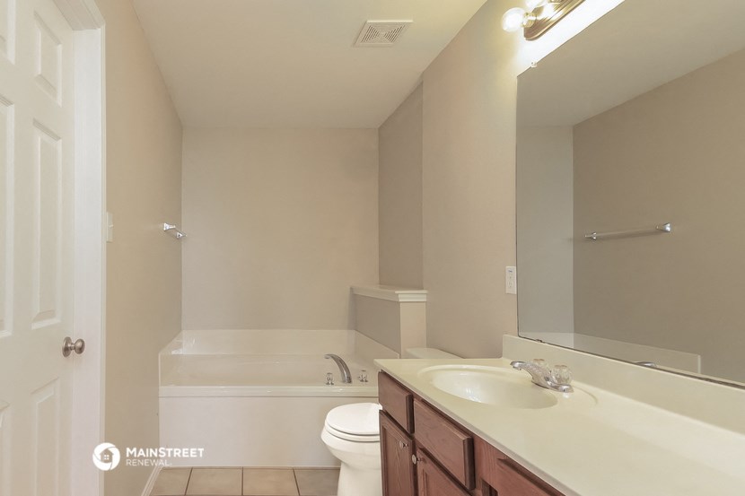 a bathroom with a sink and a toilet and a bath tub