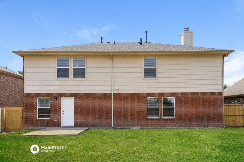 the front of a brick house with a white door