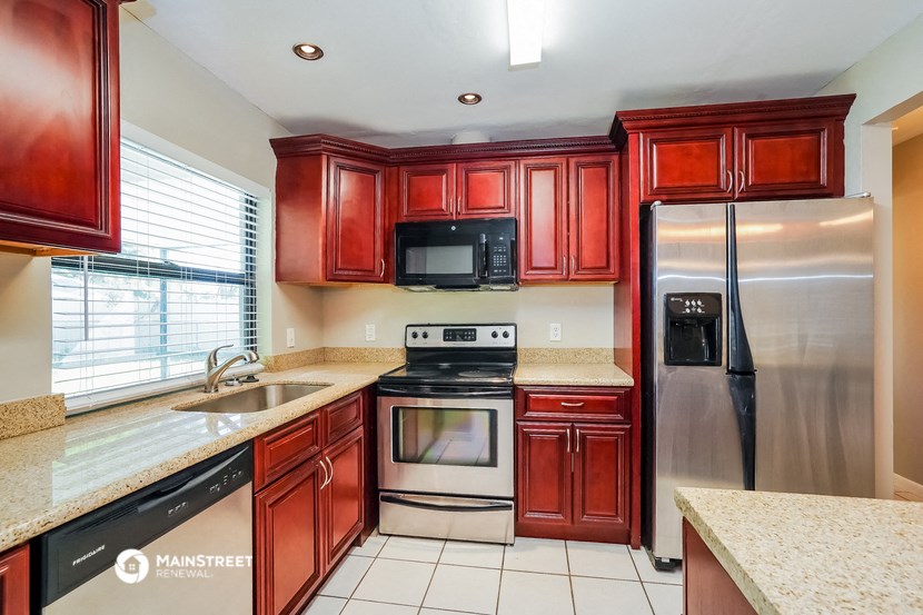 the kitchen is equipped with stainless steel appliances and granite counter tops