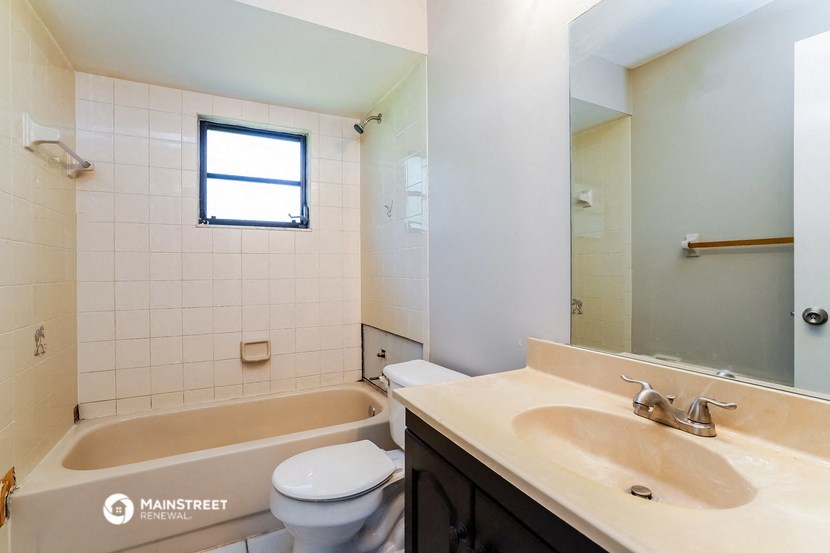 a bathroom with a sink and a toilet and a tub