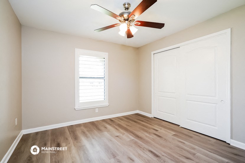 the bedroom of our studio apartment atrium with a ceiling fan