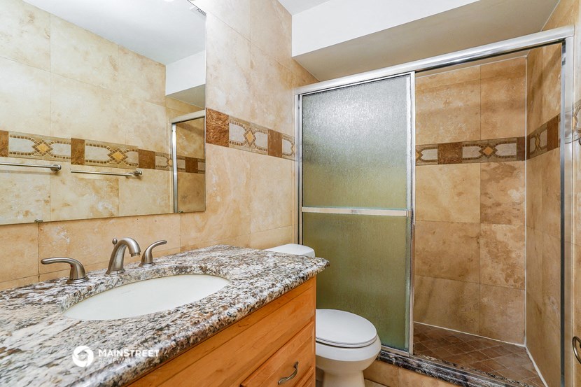 a bathroom with a sink toilet and shower