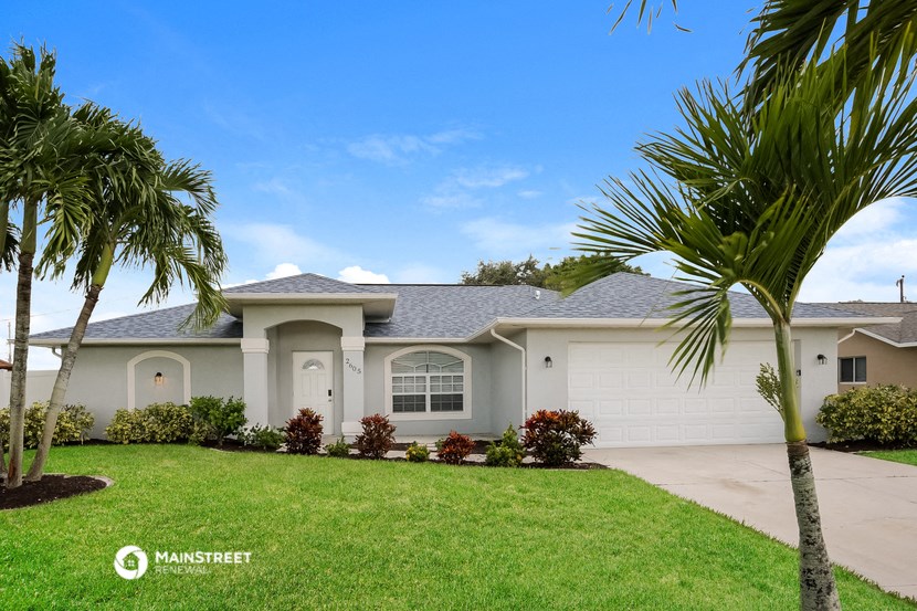 a house with palm trees in front of it