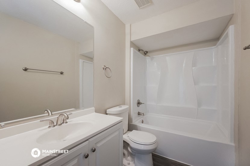 a bathroom with a sink toilet and a shower