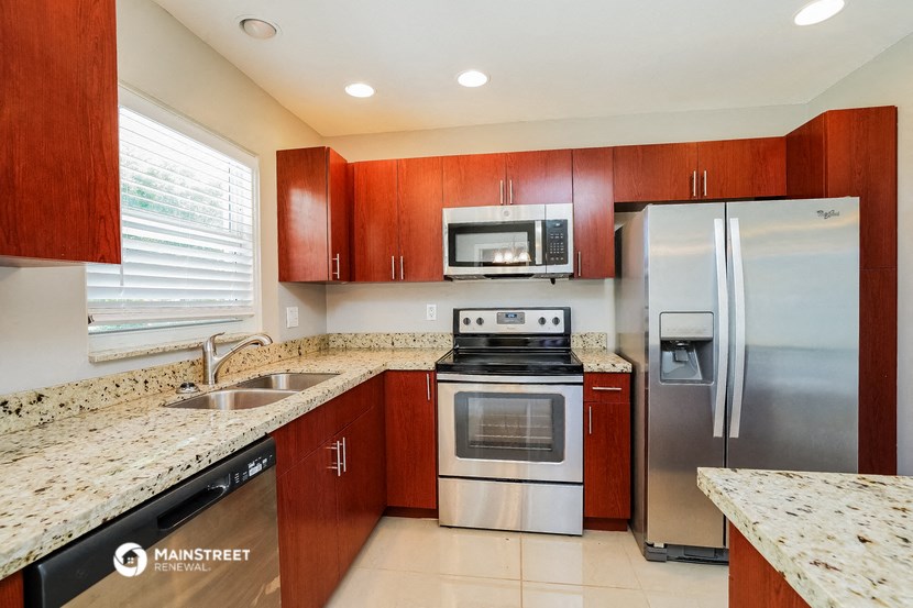 a kitchen with stainless steel appliances and granite counter tops