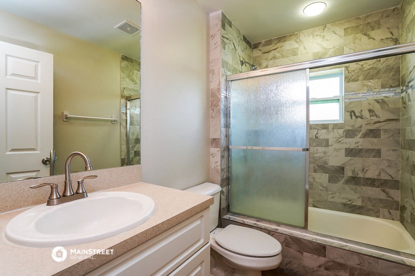 a bathroom with a sink toilet and a shower