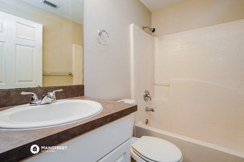 a bathroom with a sink and a shower and a toilet